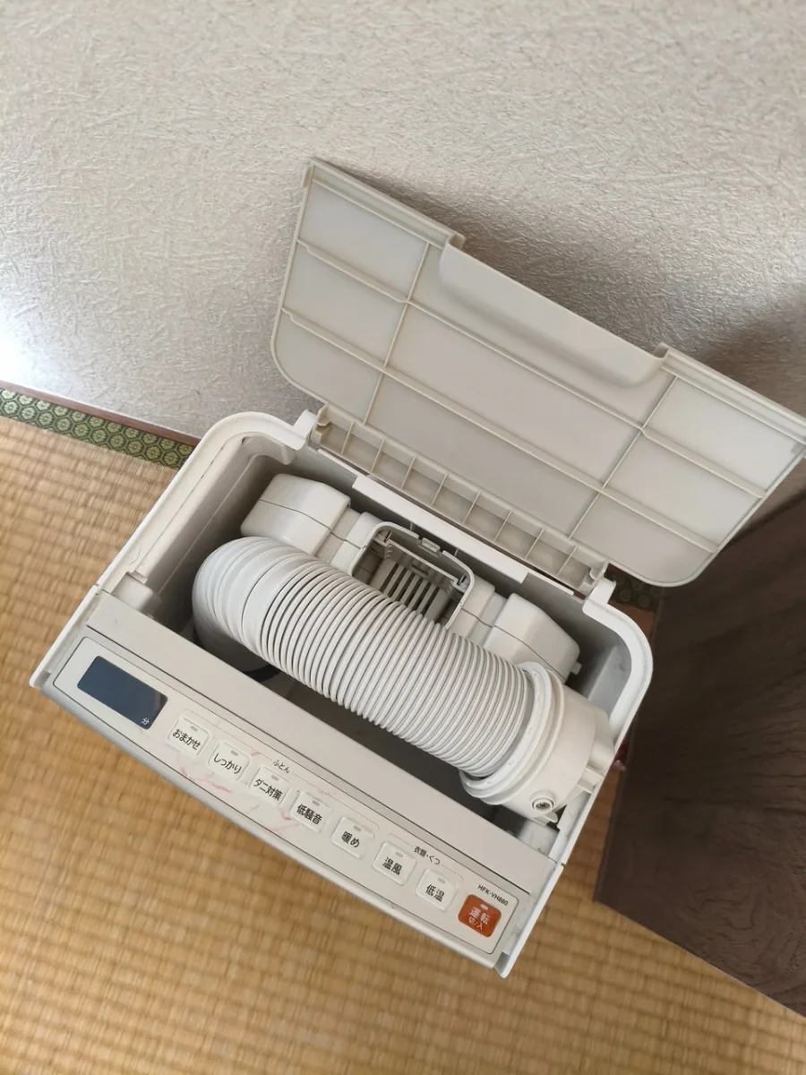 ふたを開けたHFK-VH880。ホースとアタッチメントが収納されている